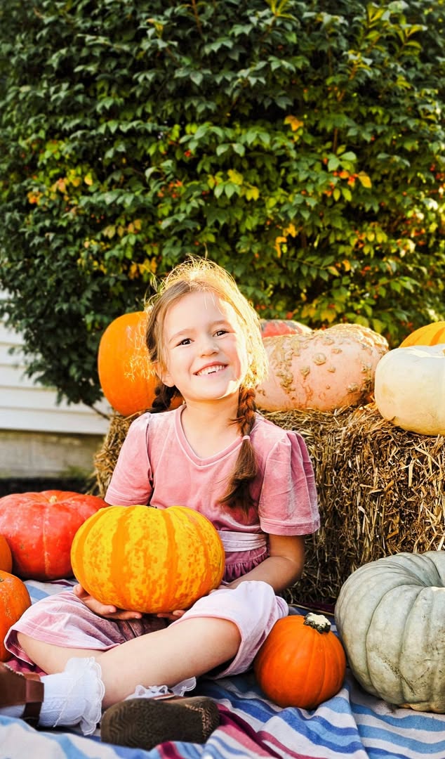 Student holding a pumpkin